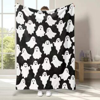 Showing size of blanket. Black with white ghosts. Covers an average adult